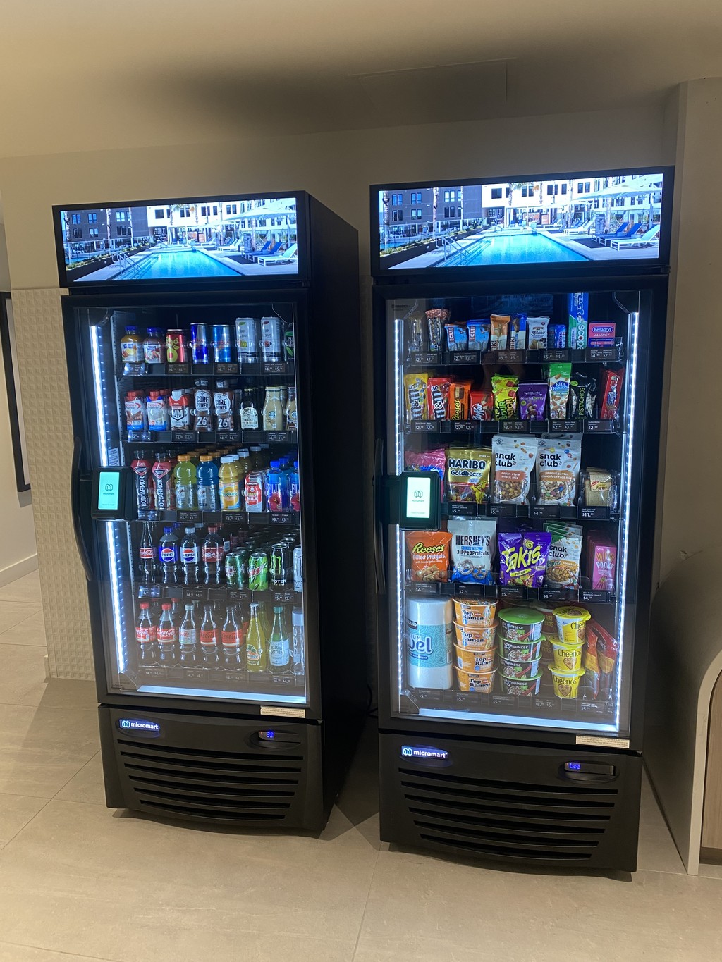Two glass-front coolers stocked with drinks and snacks.
